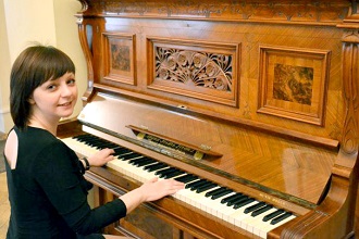 Девочка на уроке игры на фортепиано